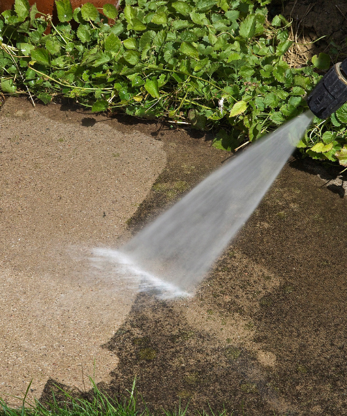 A fire hydrant spewing water onto the ground